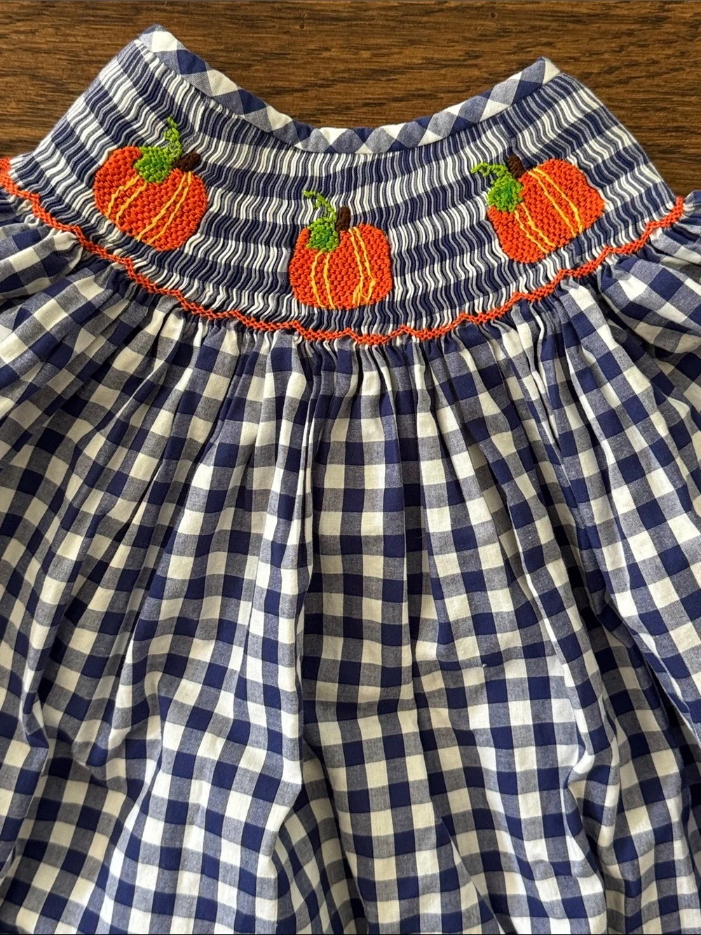 Cecil And Lou Navy Gingham Smocked Dress with Smocked Orange Pumpkin Embroidery